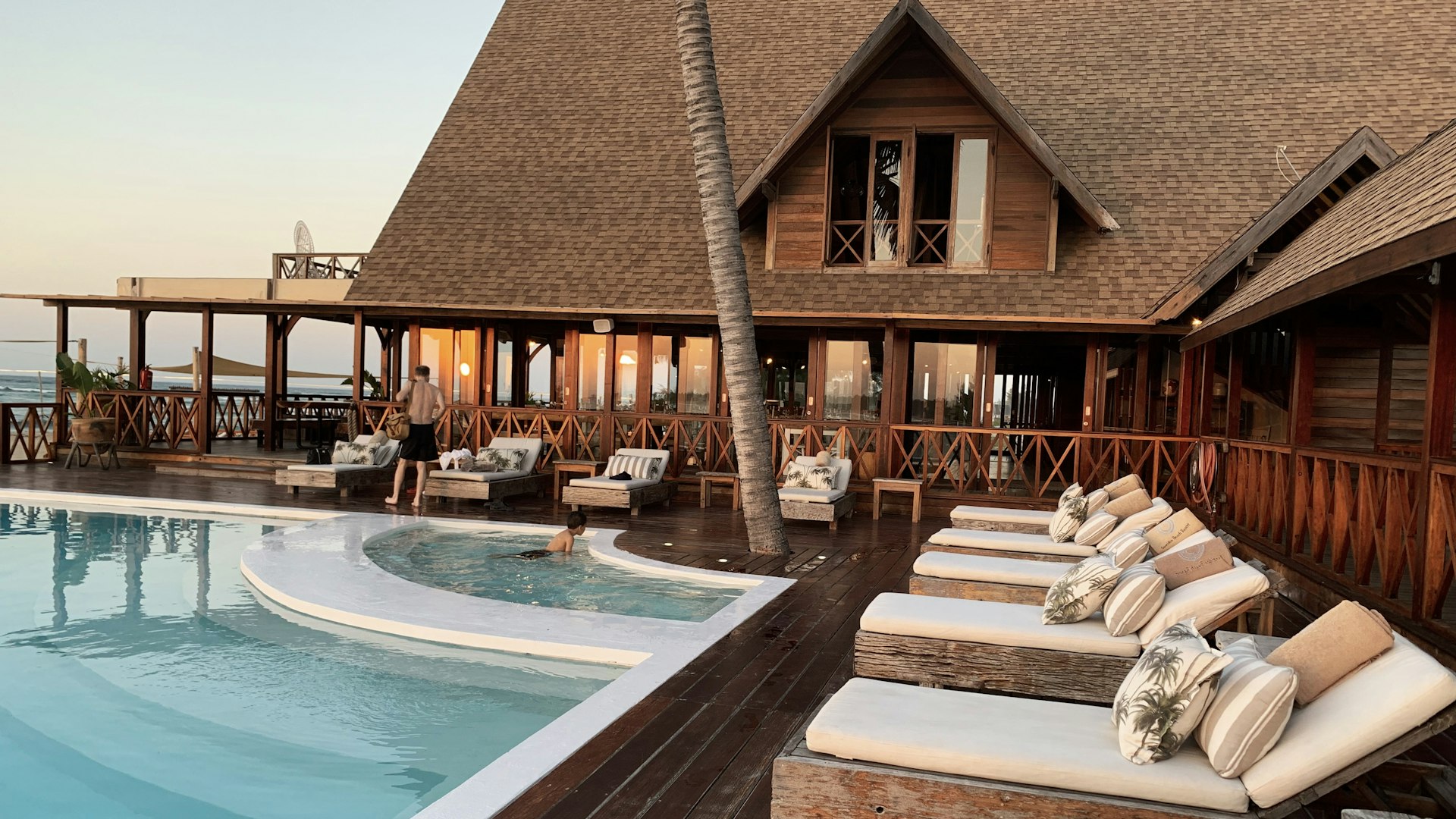 Luxury coastal resort with pool at golden hour